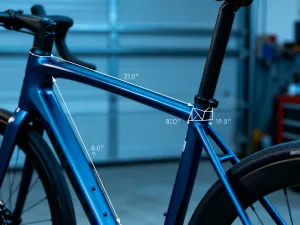 Profesjonalny pomiar rury podsiodłowej roweru szosowego za pomocą miarki w warsztacie rowerowym.
